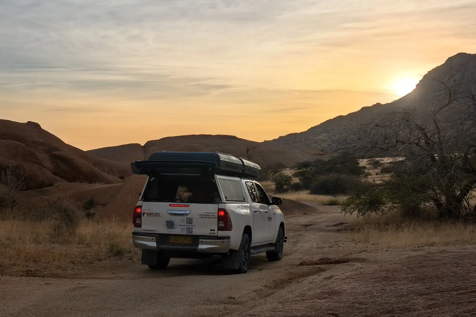 Off-road 4x4 car in Namibian desert dunes